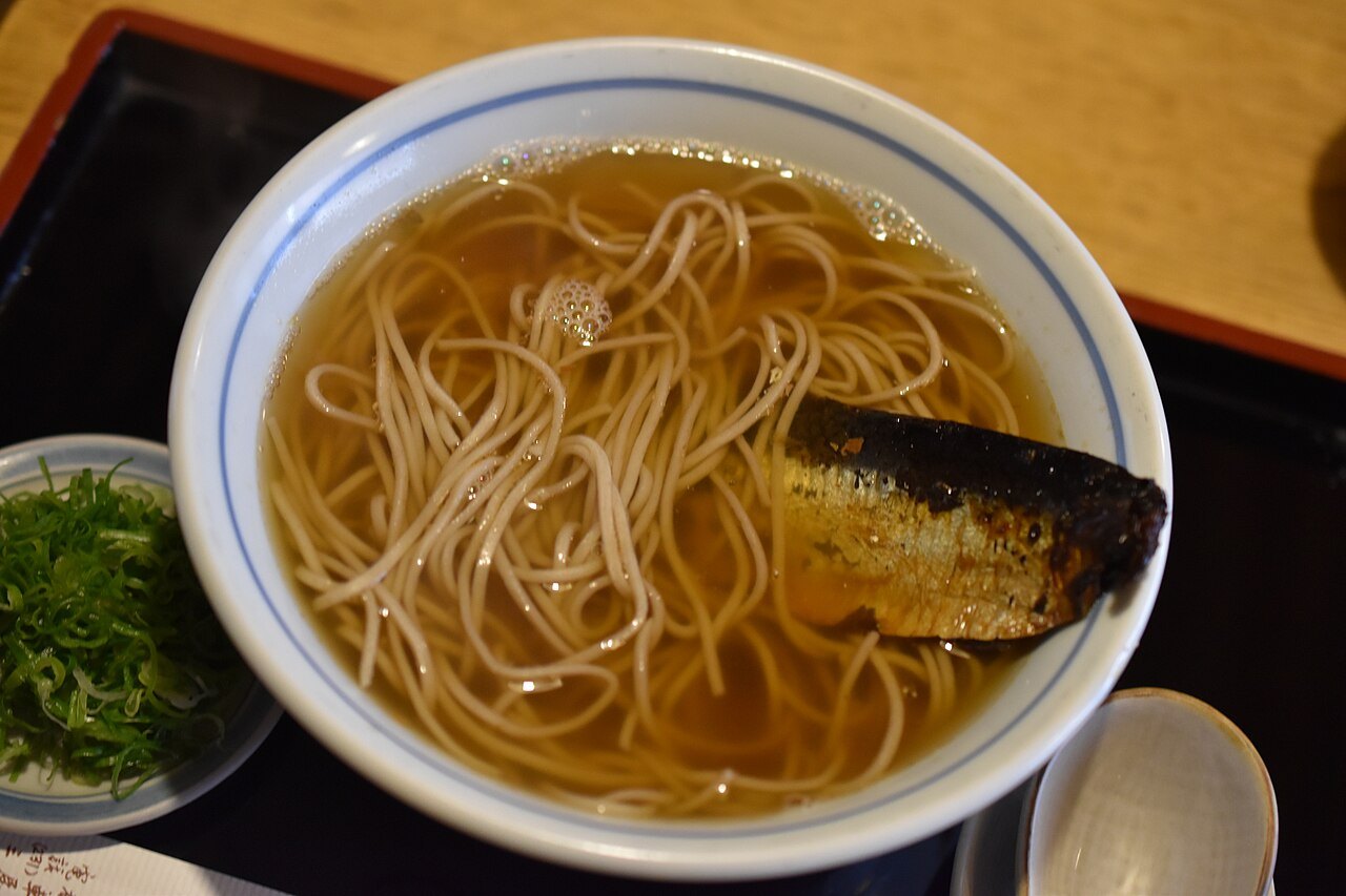 Nishin soba — buckwheat noodles under a whole dried herring, simmered sweet. Kyoto's own.